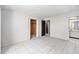 Bedroom featuring neutral walls, tiled floor, closet and ensuite bathroom at 4309 Cedar Grove St, Holiday, FL 34691