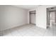 Bedroom featuring a closet, ceramic tile flooring and neutral paint at 4309 Cedar Grove St, Holiday, FL 34691