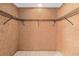 Walk-in closet with custom shelving and tile flooring at 4309 Cedar Grove St, Holiday, FL 34691