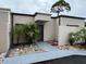 Charming townhome featuring a unique tree overhanging, stone walkway, and neutral paint scheme at 4309 Cedar Grove St, Holiday, FL 34691
