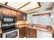 This kitchen features wood cabinets, modern appliances, and a breakfast bar open to the living room at 4309 Cedar Grove St, Holiday, FL 34691