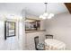 A spacious room with an open floorplan, and a view of the adjacent kitchen and front door at 4309 Cedar Grove St, Holiday, FL 34691
