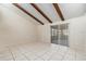 This is a bright, open living space with vaulted ceilings, exposed beams, and large sliding glass door at 4309 Cedar Grove St, Holiday, FL 34691