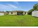 Lush backyard featuring a screened patio, well-maintained lawn, and a storage shed at 5153 Bayley St, North Port, FL 34288