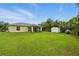 Spacious backyard with a screened patio, grassy lawn, and convenient storage shed at 5153 Bayley St, North Port, FL 34288