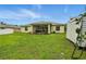 Expansive backyard with a screened patio, lush lawn, and storage shed at 5153 Bayley St, North Port, FL 34288