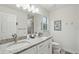 Bright bathroom with double sinks, granite countertop, and large mirror at 5153 Bayley St, North Port, FL 34288