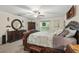 Bedroom featuring a dark wood bed frame, a ceiling fan, and large windows at 5153 Bayley St, North Port, FL 34288