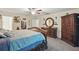 Bedroom with elegant dark furniture, including a large dresser and armoire at 5153 Bayley St, North Port, FL 34288