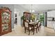 Elegant dining area with a wooden table, chairs, chandelier, and a decorative china cabinet at 5153 Bayley St, North Port, FL 34288
