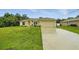 Charming single-story home with a well-manicured lawn and a paved driveway at 5153 Bayley St, North Port, FL 34288