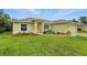 Well-maintained single-Gathering home with a lush green lawn and tidy landscaping at 5153 Bayley St, North Port, FL 34288