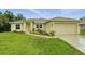 Charming single-story home with a well-manicured lawn and inviting front entrance at 5153 Bayley St, North Port, FL 34288
