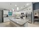 Spacious kitchen featuring white cabinets, granite countertops and stainless-steel appliances at 5153 Bayley St, North Port, FL 34288