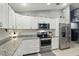 Kitchen with granite countertops, stainless-steel appliances, and ample cabinet space at 5153 Bayley St, North Port, FL 34288
