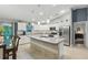 Bright kitchen features white cabinetry, stainless steel appliances, granite counters, and an island at 5153 Bayley St, North Port, FL 34288