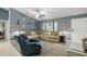 Comfortable living room with a vaulted ceiling, ceiling fan, and large sectional sofa at 5153 Bayley St, North Port, FL 34288