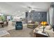 Open-concept living room featuring a comfortable seating area with access to kitchen and dining room at 5153 Bayley St, North Port, FL 34288