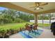 Cozy screened patio featuring an outdoor dining set and a serene view of the backyard at 5153 Bayley St, North Port, FL 34288