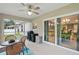 Inviting screened patio with a ceiling fan, dining set, and sliding doors to the home's interior at 5153 Bayley St, North Port, FL 34288