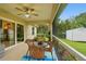 Screened patio with an outdoor dining set offering views of the backyard and storage shed at 5153 Bayley St, North Port, FL 34288
