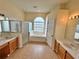 Bathroom featuring double sinks, a separate shower, and a relaxing soaking tub at 6213 Ashfield Pl, Wesley Chapel, FL 33545