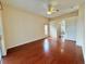 Comfortable bedroom with hardwood floors, a ceiling fan, and a large window at 6213 Ashfield Pl, Wesley Chapel, FL 33545