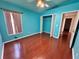 Bedroom featuring a closet, window, and hardwood floors at 6213 Ashfield Pl, Wesley Chapel, FL 33545