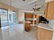 Open concept kitchen with island and adjacent living space at 6213 Ashfield Pl, Wesley Chapel, FL 33545