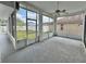 Enclosed lanai offering an outdoor living space with a view of the backyard at 6213 Ashfield Pl, Wesley Chapel, FL 33545