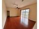 Spacious living room with hardwood floors and sliding glass doors at 6213 Ashfield Pl, Wesley Chapel, FL 33545