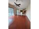 Inviting living room with hardwood floors, a ceiling fan, and sliding doors to the lanai at 6213 Ashfield Pl, Wesley Chapel, FL 33545