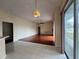 Open living space with tile and wood flooring with view to exterior at 6213 Ashfield Pl, Wesley Chapel, FL 33545