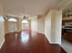 Open-concept living room with hardwood floors, a ceiling fan, and natural light at 6213 Ashfield Pl, Wesley Chapel, FL 33545
