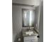 Bathroom featuring a granite-topped vanity, decorative mirror, and white cabinetry at 639 48Th N Ave, St Petersburg, FL 33703