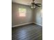 Bedroom featuring luxury vinyl floors, updated ceiling fan, and light filled windows at 639 48Th N Ave, St Petersburg, FL 33703