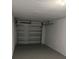 Garage featuring an updated metal door and concrete floors at 639 48Th N Ave, St Petersburg, FL 33703