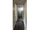 Hallway view to the bathroom with modern luxury vinyl plank flooring and fresh paint at 639 48Th N Ave, St Petersburg, FL 33703