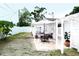 Backyard features a patio with an outdoor table and seating and lattice archway at 6508 Lenore Dr, Tampa, FL 33634