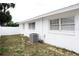 White brick house featuring an air conditioning unit and fenced-in backyard at 6508 Lenore Dr, Tampa, FL 33634