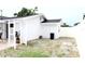 White home exterior with white lattice archway and partially grassy backyard area at 6508 Lenore Dr, Tampa, FL 33634