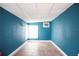 Unfinished basement with concrete tile flooring, blue painted walls and drop ceiling tiles at 6508 Lenore Dr, Tampa, FL 33634