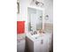 Bathroom with a white vanity, modern fixtures, and decorative wall tile at 6508 Lenore Dr, Tampa, FL 33634