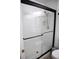 Bathroom features a glass enclosed shower with white tiled walls and a modern shower head at 6508 Lenore Dr, Tampa, FL 33634
