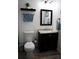 Bathroom features a modern vanity with a mirror, towel rack and blue accent towels at 6508 Lenore Dr, Tampa, FL 33634