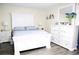 Cozy bedroom featuring hardwood floors, a comfortable bed, and a white dresser at 6508 Lenore Dr, Tampa, FL 33634