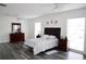 Bright bedroom with a ceiling fan, hard wood floors and two large windows at 6508 Lenore Dr, Tampa, FL 33634