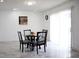 Cozy dining area features a glass-top table and a sliding glass door that provides ample natural light at 6508 Lenore Dr, Tampa, FL 33634