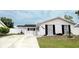 Charming single-story home with a white exterior, black shutters, and a well-maintained front yard at 6508 Lenore Dr, Tampa, FL 33634