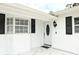 Close-up of the front door, white brick, and black shutters at 6508 Lenore Dr, Tampa, FL 33634